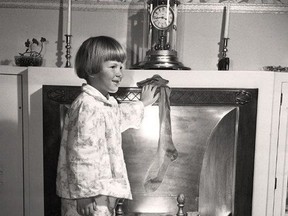 Five-year-old Gail Plaskett hangs her stocking in this Beacon Herald photo from Dec. 24, 1946. (Stratford-Perth Archives)