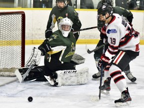 Tyson Hall of the Mitchell Hawks can't control this bouncing puck beside the open net and Mount Forest Patriots' goalie Michael Brassor during PJHL regular season action Dec. 18. Hall did score later in the game in a 4-2 win.