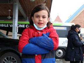 Emmett Stephenson, 10, from Petrolia lines up to get a COVID-19 vaccine dose from the province's retrofitted GO bus on Wednesday December 1, 2021 in Petrolia, Ont. Terry Bridge/Sarnia Observer/Postmedia Network