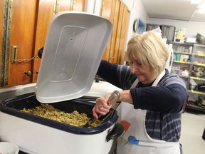 Joan Lake checks the stuffing while she and other volunteers from Trinity Anglican Church in Sarnia prepare a meal Thursday in the kitchen at the Inn of the Good Shepherd Soup Kitchen.