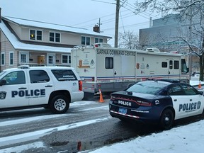 Sarnia police vehicles, including the command post, are shown parked Wednesday morning on Watson Street, on the corner of London Road. (Paul Morden / The Observer)