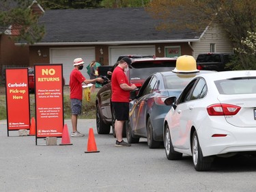 Customers line up in their vehicles for curbside pick-up at Home Hardware in Lively, Ont. on Wednesday May 19, 2021. John Lappa/Sudbury Star/Postmedia Network