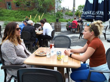 Lauren Oliver, left, and Lisa Labrecque have lunch on the patio at Di Gusto restaurant in Sudbury, Ont. on Friday June 11, 2021. Ontario moved into Step One of its reopening plan on Friday, three days ahead of schedule. Step One includes allowing non-essential retail stores to reopen, and bars and restaurants to begin serving customers on their patios. John Lappa/Sudbury Star/Postmedia Network