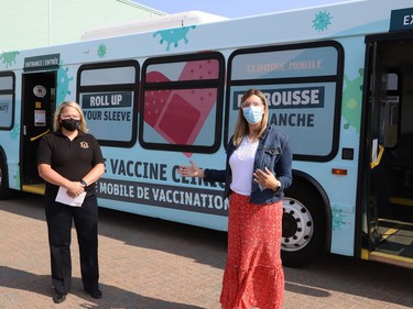 Melissa Roney, left, operations section chief for the mobile clinic with the City of Greater Sudbury, and Karly McGibbon, public health nurse with Public Health Sudbury and Districts, take part in the launch of a mobile COVID-19 vaccination clinic in Sudbury, Ont. on Monday July 12, 2021. John Lappa/Sudbury Star/Postmedia Network