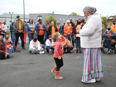 Elder Julie Ozawagosh addresses a crowd as Eleanore Richardson, 3, gets up close at a ceremony marking National Day for Truth and Reconciliation and Orange Shirt Day at the N'Swakamok Native Friendship Centre on Sept. 30. John Lappa/Sudbury Star