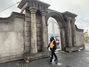 Crew member Casey Stranges strolls past a set for the Resident Evil movie in this file photo. The temporary piece of architecture was erected in a parking lot behind the Ledo Hotel as the production moved to downtown Sudbury to shoot some scenes.