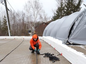 Patrick Drolet assembles the borders for an outdoor rink in Sudbury, Ont. on Thursday December 2, 2021. John Lappa/Sudbury Star/Postmedia Network