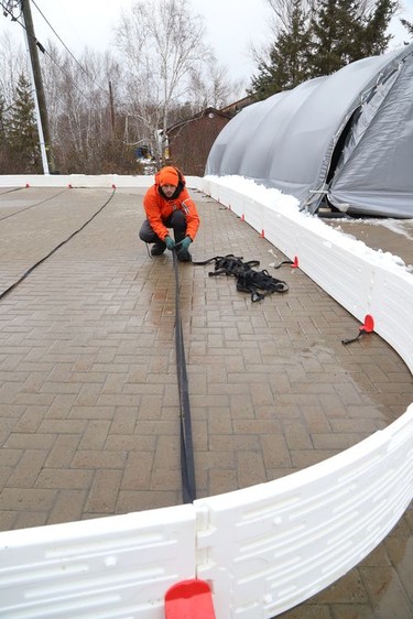 Patrick Drolet assembles the borders for an outdoor rink in Sudbury, Ont. on Thursday December 2, 2021. John Lappa/Sudbury Star/Postmedia Network