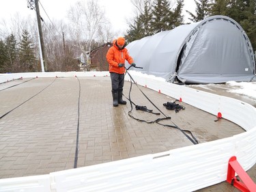 Patrick Drolet assembles the borders for an outdoor rink in Sudbury, Ont. on Thursday December 2, 2021. John Lappa/Sudbury Star/Postmedia Network