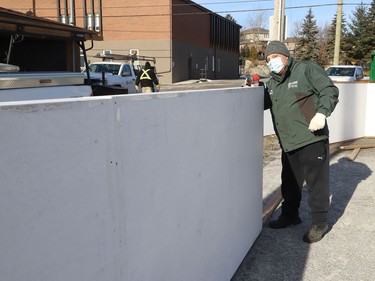 City employee Filippo Costantini works on installing new boards at Riverdale Playground in Sudbury, Ont. on Friday December 3, 2021. John Lappa/Sudbury Star/Postmedia Network