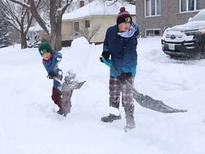 Connor Timmers, 9, left, and his brother, Bennett, 12, shovel snow off the driveway at their home in Lively, Ont. on Monday December 6, 2021. Environment Canada said Greater Sudbury can expect mainly sunny skies with a high of -12 C Tuesday. Wind chill will be -25 C in the morning and -15 C in the afternoon. John Lappa/Sudbury Star/Postmedia Network