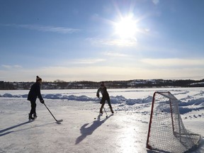 Dax Rolston, 13, left, and Tomas Corsi, 12, play a game of shinny on Robinson Lake in Sudbury, Ont. on Tuesday December 7, 2021. John Lappa/Sudbury Star/Postmedia Network