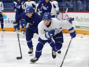 Sudbury Wolves forwards Ethan Larmand (45) and Evan Konyen (91) take part in a practice at Sudbury Community Arena in Sudbury, Ont. on Friday December 10, 2021.