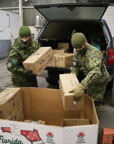 Members of the Second Battalion Irish Regiment of Canada unload food items collected for the Edgar Burton Christmas Food Drive and Kids Helping Kids Campaign at the Sudbury Food Bank in Sudbury, Ont. on Wednesday December 15, 2021. John Lappa/Sudbury Star/Postmedia Network