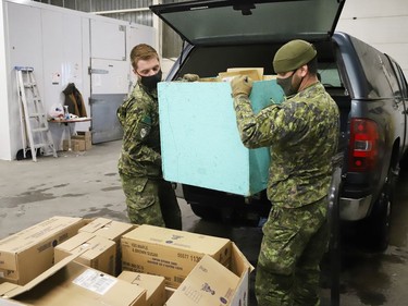 Members of the Second Battalion Irish Regiment of Canada unload food items collected for the Edgar Burton Christmas Food Drive and Kids Helping Kids Campaign at the Sudbury Food Bank in Sudbury, Ont. on Wednesday December 15, 2021. John Lappa/Sudbury Star/Postmedia Network