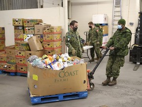Members of the Second Battalion Irish Regiment of Canada unload food items collected for the Edgar Burton Christmas Food Drive and Kids Helping Kids Campaign at the Sudbury Food Bank last year.