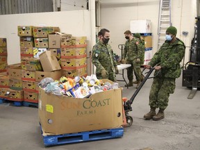 Members of the Second Battalion Irish Regiment of Canada unload food items collected for the Edgar Burton Christmas Food Drive and Kids Helping Kids Campaign at the Sudbury Food Bank in December of last year.