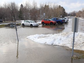 A large pool of water flooded a section of a city parking lot on York Street in Sudbury, Ont. on Thursday December 16, 2021, because of the mild temperatures Greater Sudbury has been experiencing. It will be a bit cooler on Friday, with a hig of 3 degrees C with a chance of flurries. John Lappa/Sudbury Star/Postmedia Network