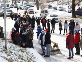 People wait in line at a vaccination clinic at the Garson arena on Dec. 21.