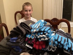 Stellan Newbury-Hodge prepares the hats, mitts, neck warmers and Tim Hortons gift cards he and his mom, Della Newbury, delivered to The Samaritan Centre on Thursday. Supplied