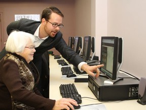 Brian Harding, shown in this file photo, helps Bobby Belfry navigate the Greater Sudbury Memories website. Harding has been appointed CEO and chief librarian of the Greater Sudbury library system.