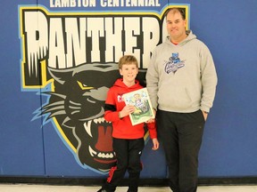 Lambton Centennial Public School student-athlete Cash McKinnon and teacher/cross-country coach/author Steve McGrail stand with a copy of McGrail's new book entitled A Heart Full of Cash. Carl Hnatyshyn/Sarnia This Week