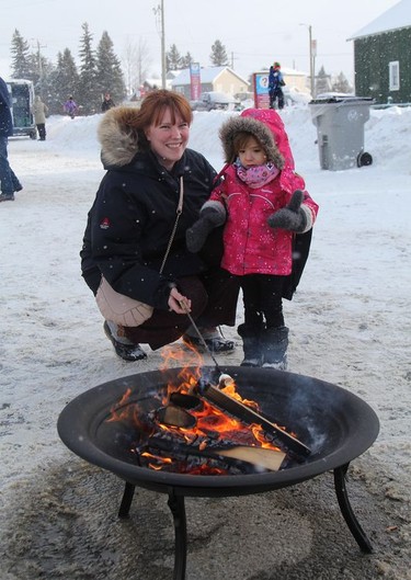 Samantha Gaudet and her daughter Jasmine, 2, took the opportunity to roast marshmallows on Second Avenue in front of the Timmins Public Library during the Holiday Fun Day even held Saturday afternoon.

RON GRECH/The Daily Press