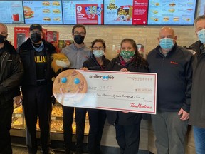 This year's Tim Horton's Smile Cookie Campaign was a major success, as a cheque for $35,205 was officially  resented to the D.A.R.E. program at the Algonquin Boulevard East location on Monday morning. From left, Rick Lemieux, Mario Pittui, David Venneri, Linda Venneri, Francine Denis, John Healey and Paul Harrison.

ANDREW AUTIO/The Daily Press