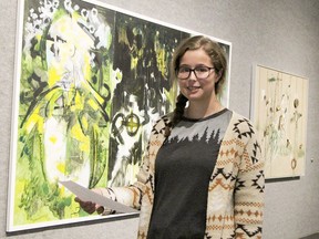 Ryleigh Belec, an attendant with the Timmins Museum, shows some of the works by Northern Ontario artist Bruce Cull that are featured in an exhibition which opened this week entitled "Connections and Responses." It will be on display in the museum's Grey Gallery until Jan. 23.

RON GRECH/The Daily Press