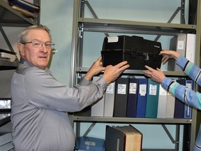 Nestled in one of the vaults in the West Perth administration office in Mitchell is a time capsule that the former Township of Hibbert created for their Sesquicentennial in 1996 that was to be opened Dec. 31, 2021. Former Hibbert Reeve and current West Perth Mayor Walter McKenzie, with the help of Pat Taylor, former Hibbert clerk-treasurer and retired West Perth clerk, lift the time capsule from the shelf. West Perth will open it sometime in 2022 - they hope. ANDY BADER/MITCHELL ADVOCATE