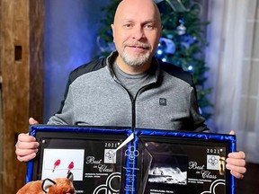 Trevor Pottelberg with his 2021 photography awards and his red fox good luck charms. (Submitted)