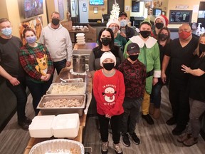 More than 150 free Christmas Eve dinners were given out Friday night during the annual 'Flippin' Mike's Boss Leaf Christmas' event in Tillsonburg. Volunteers, staff, organizers and family included Ethan, Brayden, Mike and Christina Gazley, Mary and Don Davis, Sandra and Mike Jourdy, Nancy and Corey Ouellette, and Mike and Melodie Boyle. (Chris Abbott/Norfolk and Tillsonburg News)