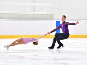 Junior pair Marty Haubrich and Summer Homick perform a spiral. (Danielle Earl)