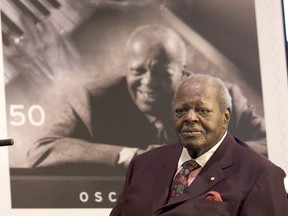 Oscar Peterson in front of his stamp during his 80th birthday celebration in 2005 during the unveiling of Oscar Peterson stamp in Toronto. Peterson died in 2007. File photo/Postmedia