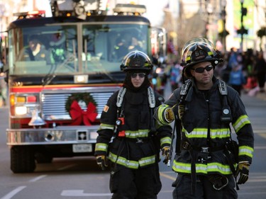Woodstock's firefighters marched with a few of their fire trucks Sunday during the Santa Claus Parade.
BRUCE URQUHART/SENTINEL-REVIEW