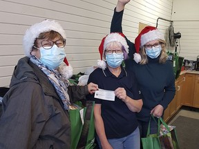 Bonnie Rowe, Dutton Dunwich-West Elgin Community Fund steering committee member, presents a $1,500 cheque to Lin McCann and Donna Mylrea from the West Elgin Daffodil Auxiliary. The auxiliary will use the funds towards a fridge for storing perishable items.