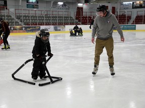 Donovan Sumner, right, an educational assistant at Washagamis Bay School gives Lake, 5, some words of encouragement during a skate at the Kenora Recreation Centre on Wednesday, Nov. 24.