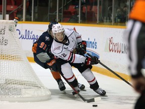 Cal Uens skates away from Owen Pitters who is in hot pursuit as the Owen Sound Attack host the Flint Firebirds inside the Harry Lumley Bayshore Community Centre Sunday, Dec. 5, 2021. Greg Cowan/The Sun Times