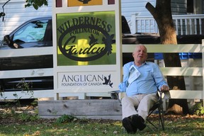 Bob Hailliday sits next to the Pollinator Garden before the start of his dedication service at St. John in the Wilderness Anglican Church in Bright's Grove.