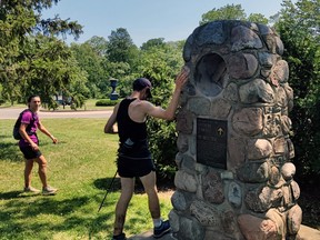 Kip Arlidge touches the rock cairn near Niagara Falls to mark the end of his 890-kilometre trek along the Bruce Trail.  Arlidge, of Sundridge ran the 890 kilometres of  the Bruce Trail in just more than nine days. Arlidge, 28, a part-time Biotechnology professor at Canadore College in North Bay, ran the equivalent of two-and-a-half marathons each day for nine days. He started off in Tobermory at the north end of the Bruce Trail June 18, arriving at the southern end of the trail in Niagara Falls June 27, completing the gruelling trek in nine days, three hours and 27 minutes. Arlidge's time surpassed the previous record set last fall by John Harrison Pockler of Toronto. Pockler's record was nine days, 17 hours and two minutes, meaning Arlidge destroyed the previous mark by nearly 14 hours.
Michael Styba Photo
