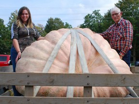 The father-and-daughter duo of Jim and Kelsey Bryson posed with their 1,777.5-pound pumpkin that topped the leaderboard at Pumpkinfest 2021. DENIS LANGLOIS