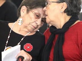 Shirley Roach is comforted by Barbara Nolan after speaking at ceremony marking signing of addendum to a covenant with Algoma University, Shingwauk Education Trust and Shingwauk Kinoomaage Gamig at Arthur A. Wishart Library at Algoma University in November 2018.