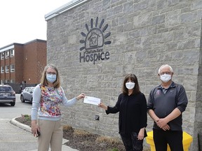 Jodi Maroney, executive director of Chatham-Kent Hospice Foundation, left, presents a $52,735 cheque to last year's winners of the CK Charity 50/50 Raffle, Jenny A. (last name not available) and her husband. (Handout/Postmedia Network)