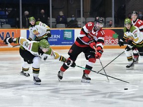 The North Bay Battalion's Matvey Petrov works to counter Cameron Tolnai of the visiting Ottawa 67's in their Ontario Hockey League game on New Year's Eve. Ottawa won 5-1 to hand the Troops a sixth straight loss. 
Submitted Photo