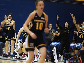 Laurentian Voyageurs celebrate on the bench during an OUA women's basketball game against the University of Toronto in Sudbury, Ontario on Saturday, November 20, 2021.