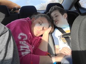 Tina Sedore sleeps alongside her 6-year-old son Lincoln on their way home from the hospital in a photo posted to the Lincoln's fight facebook page. Lincoln has been battling a brain tumour since he was one.