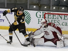 Kingston Frontenacs forward Maddox Callens tries to deflect the puck past Peterborough Petes goaltender Ty Austin in Ontario Hockey League action at the Leon's Centre in Kingston on Friday night.