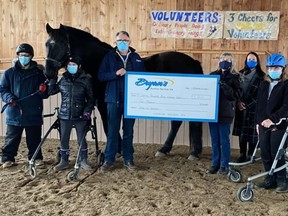 Zar, a therapy horse, is seen photographed alongside members of the Sunrise Therapeutic Riding and Learning Centre as they accept a donation from Ken Lillycrop, owner of BryanÕs Auction. Submitted.