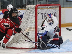 Rebecca Johnston from Team Canada tries to score on Maddie Rooney from the United States during first period action at TD Place in Ottawa on November 23, 2021.