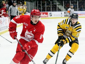 Soo Greyhounds' Jacob Holmes (6) tries to skate past Sarnia Sting's Ryan McGregor (19) in the second period at Progressive Auto Sales Arena in Sarnia, Ont., on Sunday, Nov. 24, 2019.
